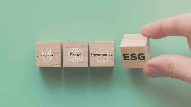 Hand flipping over wooden block of ESG, environmental social governance