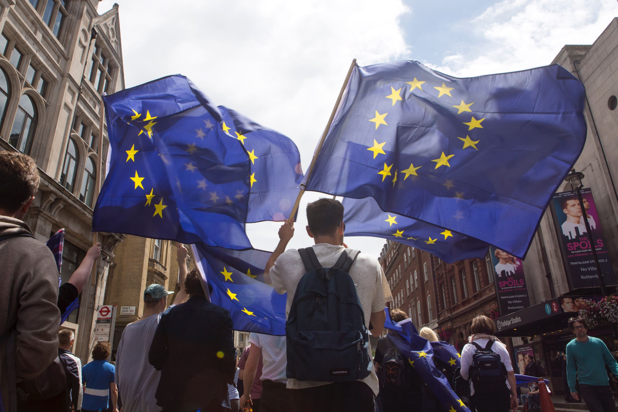 low angle view people with european-union-flags walking city street